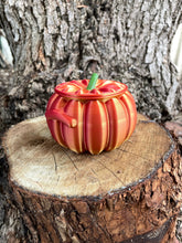 Load image into Gallery viewer, Metallic orange pumpkin-shaped object on a wooden surface