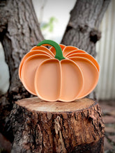 Load image into Gallery viewer, Set of pumpkin-shaped plates on a wooden stump with a tree in the background