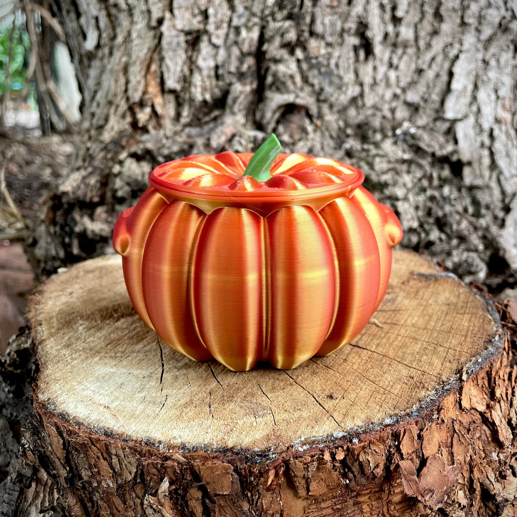 Decorative pumpkin with striped pattern on a wooden stump